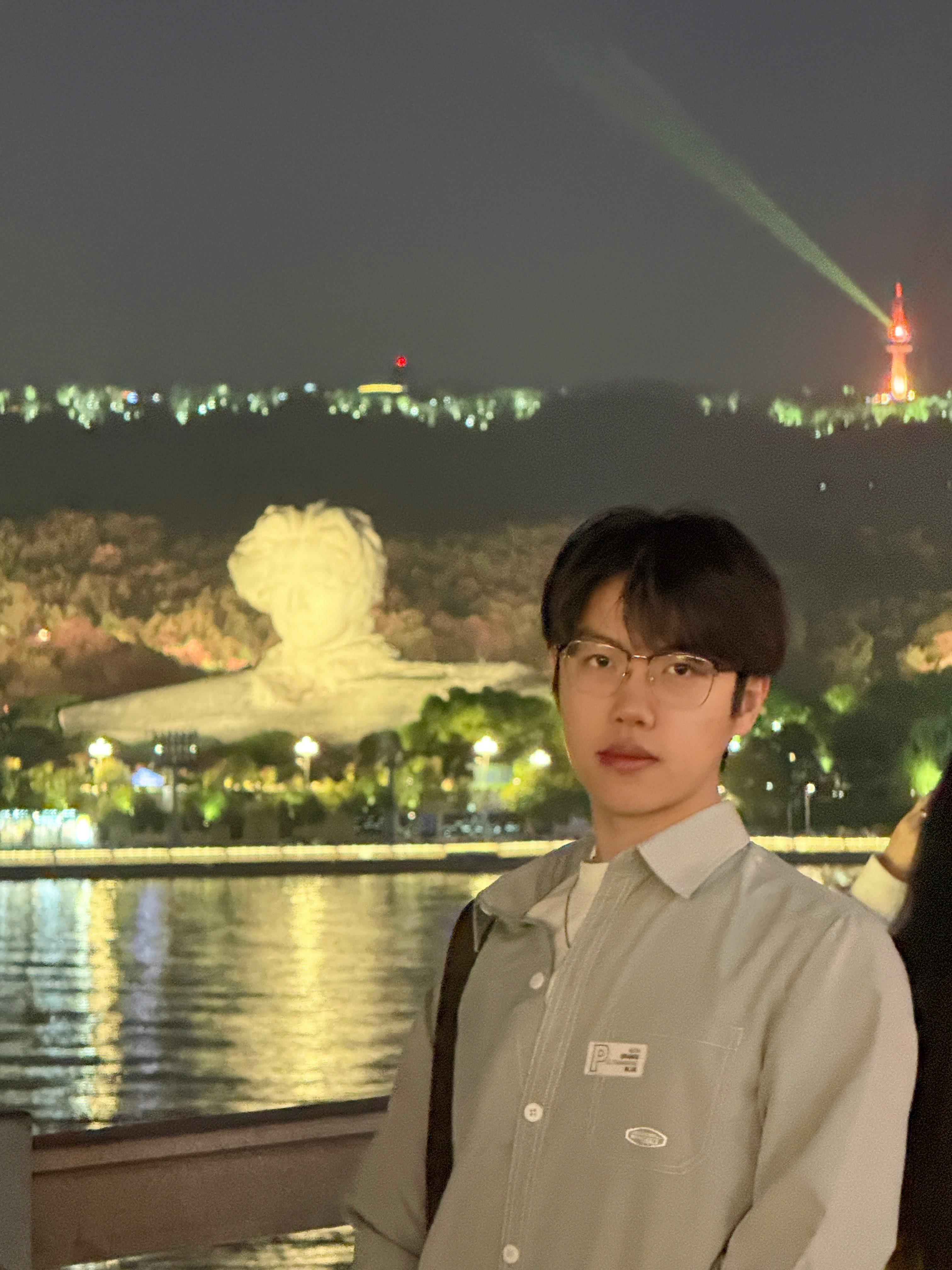 Shiyang Zhou by the river at night
